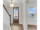 Bright foyer with hardwood floors, white trim, and a glass front door allowing natural light at 709 Maynard Ln, Summerville, SC 29486