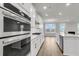 Modern kitchen featuring white cabinets, stainless steel appliances, and a large island at 709 Maynard Ln, Summerville, SC 29486