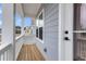 Inviting front porch with wood flooring and white railing, offering a relaxing outdoor space at 709 Maynard Ln, Summerville, SC 29486