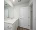 Bright bathroom featuring white vanity with a sink, a mirror, and an open doorway at 204 West Bradford Pointe Dr, Summerville, SC 29486