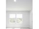 Sunlit bedroom with neutral carpet and walls featuring two windows at 204 West Bradford Pointe Dr, Summerville, SC 29486