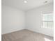 Comfortable carpeted bedroom with a window and white trim and baseboards at 319 Calm Water Way, Summerville, SC 29486