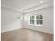 Bright bedroom features hardwood flooring and large windows for natural light at 319 Calm Water Way, Summerville, SC 29486