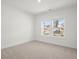Bright bedroom with a double window providing lots of natural light, and plush carpet flooring at 319 Calm Water Way, Summerville, SC 29486