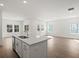 Open-concept kitchen island opens into the living room with windows and recess lighting at 319 Calm Water Way, Summerville, SC 29486
