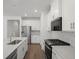 Bright kitchen features white cabinets, stainless steel appliances, marble backsplash, and center island at 319 Calm Water Way, Summerville, SC 29486