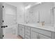 Well-lit bathroom with double sink vanity, white cabinets, and a shower/tub combo at 323 Trailmore Ln, Summerville, SC 29486