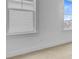 Bedroom with plush carpeting, two bright windows, and fresh white paint at 323 Trailmore Ln, Summerville, SC 29486