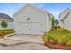 Attached two-car garage featuring a white door with black accents and exterior light at 323 Trailmore Ln, Summerville, SC 29486
