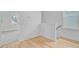 Hallway with wood floor, white walls, and natural light streaming through the window at 323 Trailmore Ln, Summerville, SC 29486