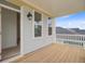Covered porch featuring wood decking, outdoor lighting, and blue painted walls at 323 Trailmore Ln, Summerville, SC 29486