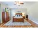 Comfortable bedroom with a wooden bed, a ceiling fan, and hardwood floors at 1129 Plantation Overlook Dr, Moncks Corner, SC 29461