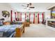 Spacious bedroom featuring two beds, a ceiling fan, three windows, and carpet flooring at 1129 Plantation Overlook Dr, Moncks Corner, SC 29461