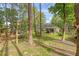 View of the home's backyard with a covered patio and picket fencing surrounded by mature trees at 119 Osage Way, Summerville, SC 29483