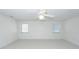 Bright bedroom featuring neutral carpet, a ceiling fan, and two windows at 1441 Waterside Ct, Mount Pleasant, SC 29464