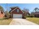 Charming red brick home with a well-manicured lawn and a two car garage at 1441 Waterside Ct, Mount Pleasant, SC 29464