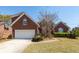 Beautiful red brick home with mature landscaping and an attached two-car garage at 1441 Waterside Ct, Mount Pleasant, SC 29464