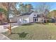 Charming home featuring a two-car garage, well-manicured lawn, and inviting entrance at 104 Lewisfield Dr, North Charleston, SC 29418