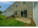 Small backyard with a patio, sliding glass door, and a white vinyl fence at 128 Gaura Ln, Summerville, SC 29483