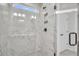 Elegant shower showcasing marble-style tiling, niche, and glass door at 336 Hillman Trail Dr, Moncks Corner, SC 29461