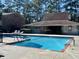 Community pool with lounge chairs and brick building nearby at 710 Andrea Ln, Hanahan, SC 29410