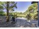 Serene backyard with pond view and wooden chairs at 26 Twin Oaks Ln, Isle of Palms, SC 29451