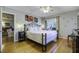 Bedroom with king bed, hardwood floors and access to a private porch at 26 Twin Oaks Ln, Isle of Palms, SC 29451