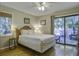 Bedroom with a queen bed, hardwood floors, and access to a balcony at 26 Twin Oaks Ln, Isle of Palms, SC 29451