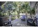 Relaxing deck overlooking lush trees and neighboring houses at 26 Twin Oaks Ln, Isle of Palms, SC 29451
