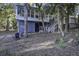 Home's exterior showcasing a unique design and surrounding greenery at 26 Twin Oaks Ln, Isle of Palms, SC 29451