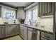 Gray cabinets, granite countertops and stainless steel appliances at 26 Twin Oaks Ln, Isle of Palms, SC 29451