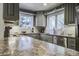 Well-lit kitchen with gray cabinets, granite countertops, and stainless steel appliances at 26 Twin Oaks Ln, Isle of Palms, SC 29451