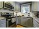 Modern kitchen with gray cabinets, stainless steel appliances, and granite countertops at 26 Twin Oaks Ln, Isle of Palms, SC 29451