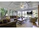 Bright sunroom with comfortable seating and a wooden coffee table at 26 Twin Oaks Ln, Isle of Palms, SC 29451