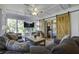 Bright sunroom features a cozy seating area, sliding barn doors, and large windows at 26 Twin Oaks Ln, Isle of Palms, SC 29451