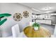 Cozy dining area with a round table, seating, and easy access to a bright kitchen with white cabinets at 2675 Houston St, North Charleston, SC 29405