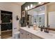 Stylish bathroom features double vanity, framed mirror, and walk-in shower with glass door at 144 Seaton Street, Summerville, SC 29486