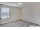 This bedroom features neutral walls, carpet, and a window allowing natural light to fill the space at 144 Seaton Street, Summerville, SC 29486