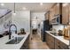 Bright kitchen with stainless steel appliances, island seating, and seamless flow to the dining area and staircase at 144 Seaton Street, Summerville, SC 29486