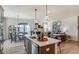 Kitchen island with seating, quartz countertops, and modern lighting, offering ample counter space for cooking at 144 Seaton Street, Summerville, SC 29486
