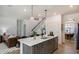 Kitchen island with seating, quartz countertops, and modern fixtures, connecting living spaces in this design at 144 Seaton Street, Summerville, SC 29486