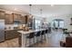 Modern kitchen with stainless steel appliances, quartz countertops, and island seating, open to dining area at 144 Seaton Street, Summerville, SC 29486