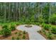 Community meditation area with walking path, manicured lawn, and lush landscaping surrounded by a wooded area at 144 Seaton Street, Summerville, SC 29486
