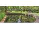 Idyllic pond with a frog sculpture and brick edging, offering a peaceful and reflective space within the community at 208 Sumter Ave, Summerville, SC 29483