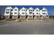 Street view of townhomes, showcasing their classic exterior design at 5142 Double Eagle Lp, Summerville, SC 29485