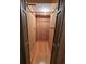 Interior view of a closet space with wood walls and hardwood floors, showcasing simple storage at 7024 E Constellation Dr, North Charleston, SC 29418