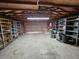 Spacious garage features shelving units, overhead lighting, and ample room for storage and parking at 7024 E Constellation Dr, North Charleston, SC 29418