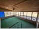 Enclosed sunroom featuring numerous windows, brick accents, and a ceiling fan at 7024 E Constellation Dr, North Charleston, SC 29418
