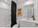 Bright bathroom with white vanity, modern fixtures, and tub-shower combo with black shower curtain at 762 Meadowbrook Ln, Summerville, SC 29486