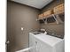 Laundry room featuring a white washer and dryer with overhead storage baskets at 764 Meadowbrook Ln, Summerville, SC 29486